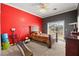 Cozy bedroom featuring an accent wall and sliding glass doors for natural light at 4200 Topsider St, Las Vegas, NV 89129