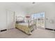 Neutral bedroom with carpet, white door, and a sliding glass door that provides bright natural light at 4200 Topsider St, Las Vegas, NV 89129