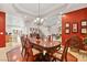 Spacious dining room with a large wooden table and elegant chandelier at 4200 Topsider St, Las Vegas, NV 89129