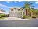 Gorgeous exterior home view with a three-car garage and desert landscaping at 4200 Topsider St, Las Vegas, NV 89129