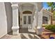 Covered front entrance featuring white columns, double doors, and decorative lanterns at 4200 Topsider St, Las Vegas, NV 89129