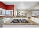 Kitchen island cooktop, stainless steel appliances, and custom window shutters provide a warm and functional space at 4200 Topsider St, Las Vegas, NV 89129