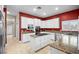 Spacious kitchen featuring a large island cooktop, stainless steel appliances, granite counters, and white cabinetry at 4200 Topsider St, Las Vegas, NV 89129