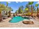 Gorgeous pool area with rock waterfall, spa, and tropical landscaping, perfect for relaxation at 4200 Topsider St, Las Vegas, NV 89129