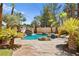 Resort-style pool with rock features, waterfall, and lush palm trees create a tranquil oasis at 4200 Topsider St, Las Vegas, NV 89129