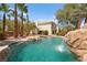 Tranquil pool with waterfall feature and lush landscaping complements the home's exterior at 4200 Topsider St, Las Vegas, NV 89129