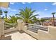 Balcony view of palm trees, neighborhood street, and distant mountains at 4200 Topsider St, Las Vegas, NV 89129