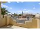 Balcony view of neighborhood homes, palm trees, and blue sky and clouds at 4200 Topsider St, Las Vegas, NV 89129