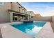 Refreshing pool in a spacious backyard, complimented by an attached spa, a fire pit, and well-maintained landscaping at 4220 Porticella Ave, North Las Vegas, NV 89084