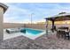 Backyard view showcasing a pool, fire pit, gazebo with a dining area, and a built-in BBQ, perfect for outdoor activities at 4220 Porticella Ave, North Las Vegas, NV 89084