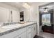 Bathroom featuring double sinks, white cabinets and granite counters at 4220 Porticella Ave, North Las Vegas, NV 89084