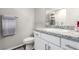 Bright bathroom featuring a vanity with granite counters, white cabinets, and modern fixtures at 4220 Porticella Ave, North Las Vegas, NV 89084