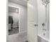 Modern bathroom featuring tub-shower combo, a double shower head, and access to the laundry room at 4220 Porticella Ave, North Las Vegas, NV 89084