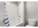 Bright bathroom showcasing a shower with a rainfall showerhead, white subway tiles, and a toilet at 4220 Porticella Ave, North Las Vegas, NV 89084