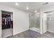 Bright bathroom featuring glass-enclosed shower, tile flooring, and access to a walk-in closet at 4220 Porticella Ave, North Las Vegas, NV 89084