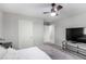 Neutral bedroom featuring a ceiling fan, carpet, and a view of the entry at 4220 Porticella Ave, North Las Vegas, NV 89084