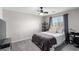 Cozy bedroom featuring a ceiling fan, plush carpet, and window with blinds at 4220 Porticella Ave, North Las Vegas, NV 89084