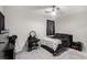 Cozy bedroom with neutral carpet, ceiling fan, and a dark color scheme at 4220 Porticella Ave, North Las Vegas, NV 89084