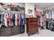 Spacious walk-in closet with shelving and hanging racks to organize clothing and accessories at 4220 Porticella Ave, North Las Vegas, NV 89084