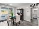 Cozy dining area with sliding door access to backyard, adjacent to a charming bar cabinet and powder room at 4220 Porticella Ave, North Las Vegas, NV 89084