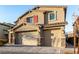 Charming two-story home featuring a two-car garage with stone accents and a well-maintained front yard at 4220 Porticella Ave, North Las Vegas, NV 89084