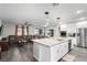 Open-concept kitchen with a large island, stainless steel appliances, and seamless flow to the living area at 4220 Porticella Ave, North Las Vegas, NV 89084