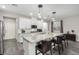 Spacious kitchen featuring granite countertops, stainless steel appliances, and an island with barstool seating at 4220 Porticella Ave, North Las Vegas, NV 89084