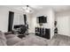 Cozy living room with dark wood-look floors, entertainment center, and gray sectional sofa at 4220 Porticella Ave, North Las Vegas, NV 89084