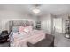 Comfortable main bedroom featuring a tufted headboard, soft lighting, and ample closet space at 4220 Porticella Ave, North Las Vegas, NV 89084