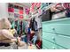 Well-organized walk-in closet with shelves, hanging racks, and a turquoise dresser at 4220 Porticella Ave, North Las Vegas, NV 89084