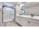 Modern bathroom with dual sinks, quartz countertops, sleek black hardware, and a glass-enclosed shower at 4341 Sunburst Spring Ave, Las Vegas, NV 89141