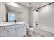 Bright bathroom featuring a large mirror, modern vanity, toilet, and a bathtub with white subway tile surround at 4341 Sunburst Spring Ave, Las Vegas, NV 89141