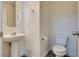 Well-lit half bathroom with a pedestal sink and sleek fixtures for guests at 4626 Lime Straight Dr, Las Vegas, NV 89115