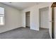 Carpeted bedroom featuring neutral paint, a closet and an entrance to a laundry room at 4626 Lime Straight Dr, Las Vegas, NV 89115