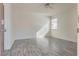 A clean bedroom features hard surface floors, white walls, a ceiling fan, and natural light at 4626 Lime Straight Dr, Las Vegas, NV 89115