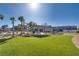 Inviting community space featuring picnic tables, green turf, palm trees, and nearby residences under a clear blue sky at 4626 Lime Straight Dr, Las Vegas, NV 89115