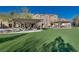 Inviting community space featuring picnic tables, trellises, green turf, and nearby residences under a clear blue sky at 4626 Lime Straight Dr, Las Vegas, NV 89115