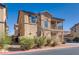 Exterior angle of a tan two-story home featuring a second-story balcony and desert landscaping at 4626 Lime Straight Dr, Las Vegas, NV 89115