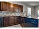 A kitchen featuring dark cabinets, granite countertops, designer backsplash, and stainless steel appliances at 4626 Lime Straight Dr, Las Vegas, NV 89115