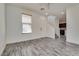 Inviting living room with wood-look tile flooring, large windows, and neutral paint at 4626 Lime Straight Dr, Las Vegas, NV 89115