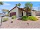 Front of home features desert landscaping, palm trees, and a covered porch at 4716 Mountain Valley Rd, Las Vegas, NV 89121