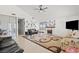 Spacious living room featuring high ceilings, tile floors, a ceiling fan, and plenty of natural light at 4716 Mountain Valley Rd, Las Vegas, NV 89121