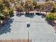 Aerial view of well-maintained tennis courts surrounded by lush trees and greenery at 4716 Mountain Valley Rd, Las Vegas, NV 89121