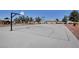 Community basketball court with well-maintained surface, hoops, benches, and mature trees at 4815 Palacio Ct, Las Vegas, NV 89122