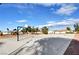 Wide shot of the community basketball court surrounded by a playground, mature trees, and desert landscape at 4815 Palacio Ct, Las Vegas, NV 89122