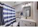 Cozy bathroom with a blue striped shower curtain and modern fixtures at 4815 Palacio Ct, Las Vegas, NV 89122