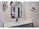 Modern bathroom vanity with a framed mirror and elegant marbled countertops at 4815 Palacio Ct, Las Vegas, NV 89122