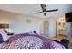 Comfortable bedroom with a ceiling fan, a decorative dresser, and an ensuite bathroom at 4815 Palacio Ct, Las Vegas, NV 89122