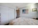 Bedroom with sliding closet and a queen bed with white walls, and carpeted floor at 4815 Palacio Ct, Las Vegas, NV 89122