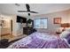 Inviting bedroom featuring a ceiling fan, decorative dresser, and a window with outside views at 4815 Palacio Ct, Las Vegas, NV 89122